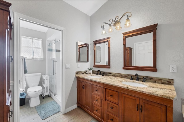 full bath with double vanity, a sink, and a shower stall