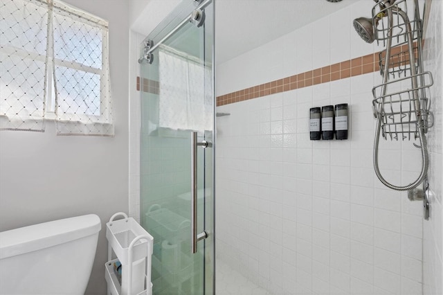 full bath featuring toilet and a shower stall