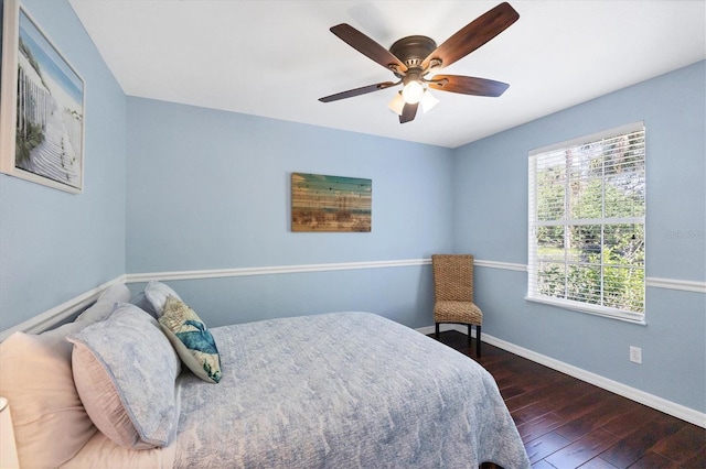 bedroom with wood-type flooring, baseboards, and a ceiling fan