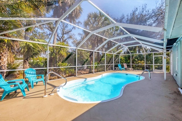 outdoor pool with glass enclosure and a patio