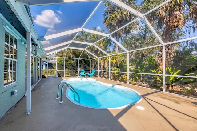 outdoor pool featuring a lanai and a patio area