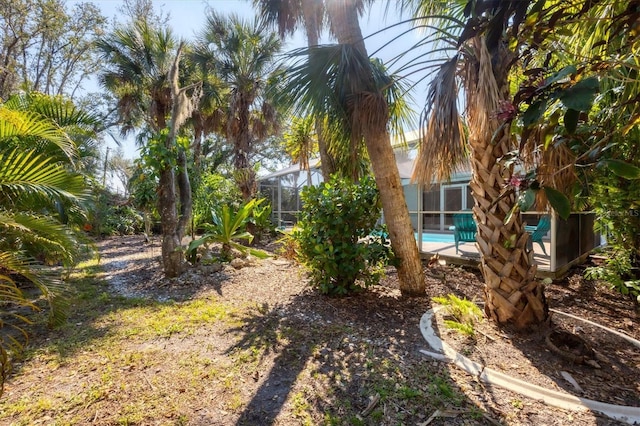 view of yard featuring a lanai and an outdoor pool