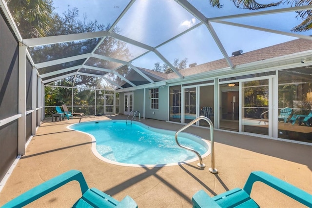 pool with french doors and a patio area