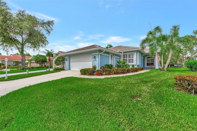 ranch-style house featuring a garage and a front yard