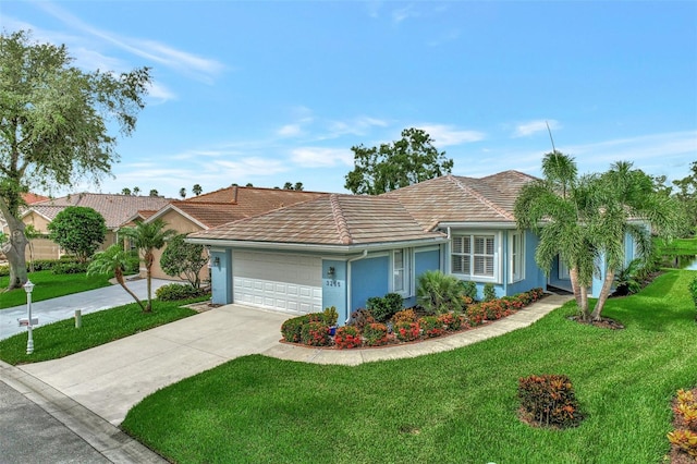 ranch-style home with a garage and a front lawn