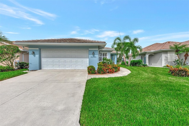 ranch-style home with a garage and a front lawn