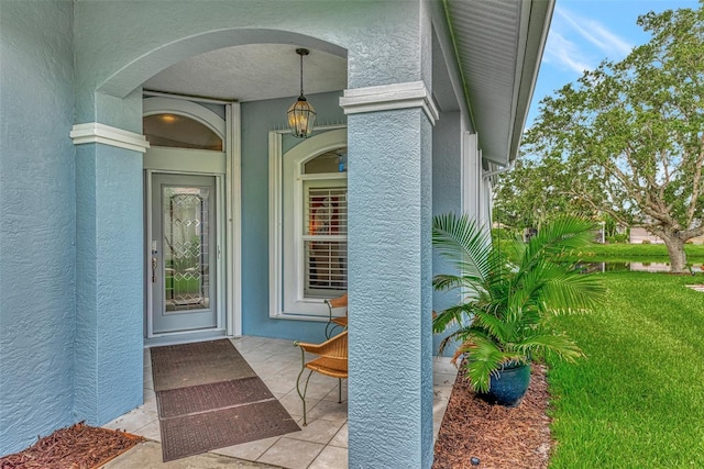 doorway to property with a lawn