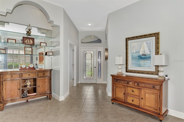 foyer entrance with light tile patterned floors