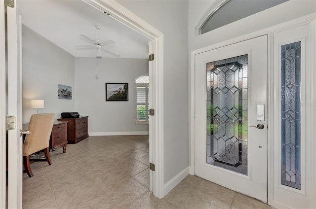 tiled foyer with ceiling fan