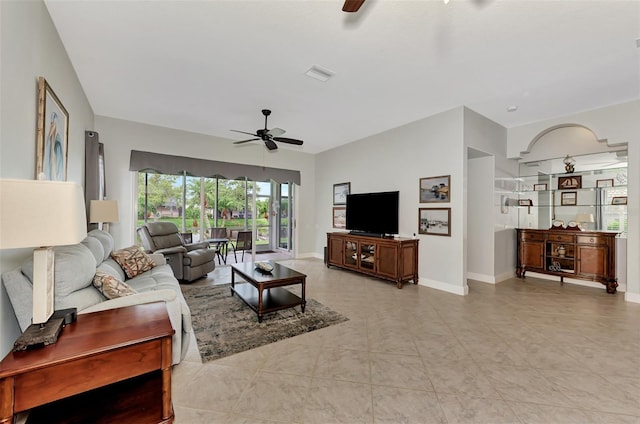 tiled living room with ceiling fan