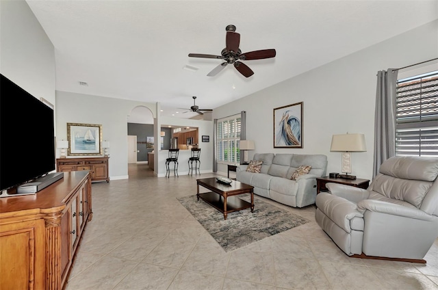 tiled living room featuring ceiling fan