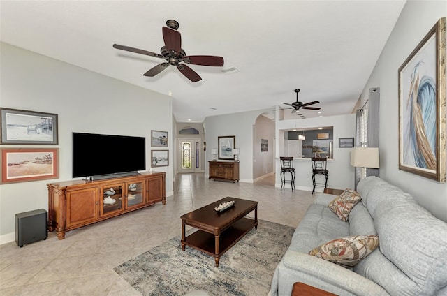 living room featuring ceiling fan and light tile patterned flooring