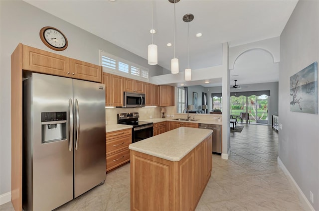 kitchen with a kitchen island, decorative light fixtures, sink, kitchen peninsula, and stainless steel appliances