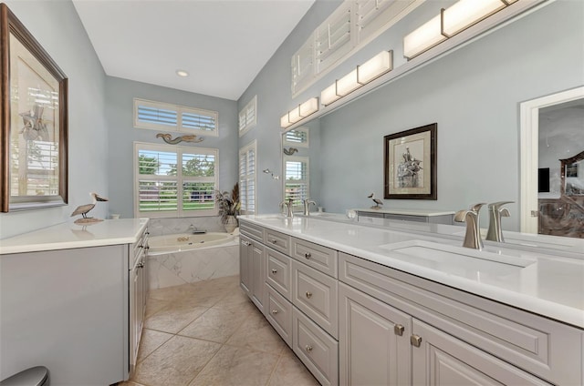 bathroom featuring a relaxing tiled tub, vanity, and tile patterned floors