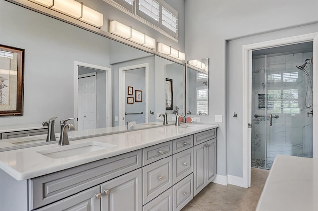 bathroom with tile patterned flooring, vanity, and an enclosed shower