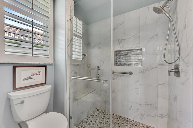 bathroom with an enclosed shower and toilet