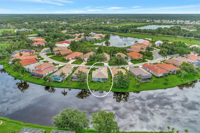 birds eye view of property with a water view