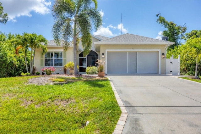 ranch-style home featuring a garage and a front lawn