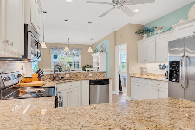 kitchen with white cabinets, backsplash, hanging light fixtures, and appliances with stainless steel finishes