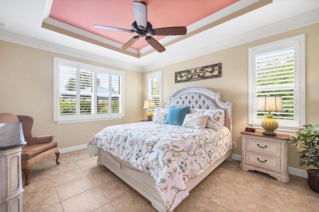 tiled bedroom with ceiling fan, a tray ceiling, and ornamental molding