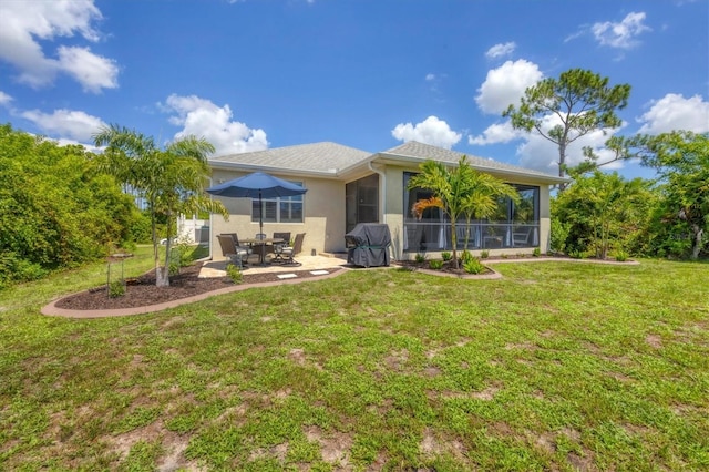 back of house featuring a sunroom, a lawn, and a patio