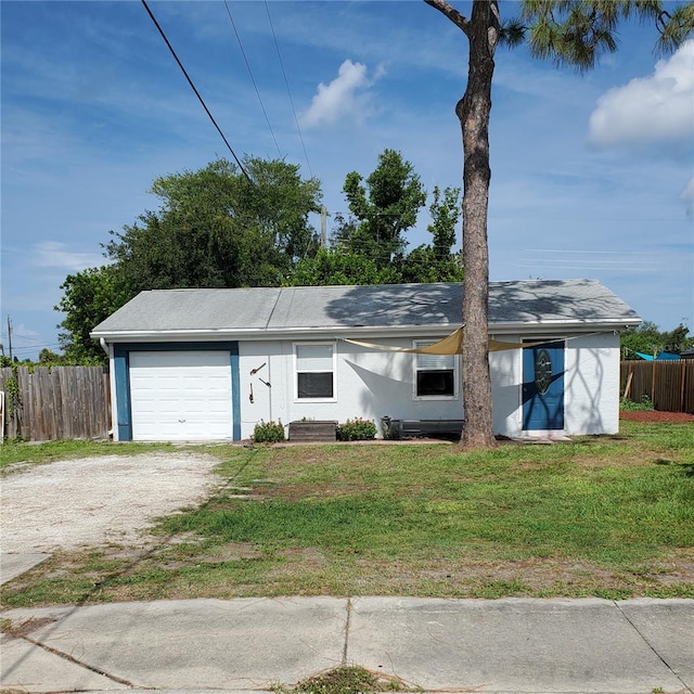 ranch-style home with a garage and a front yard