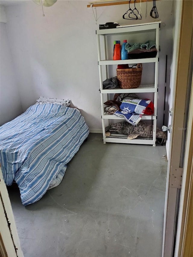 bedroom featuring concrete floors