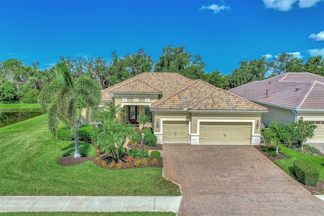 mediterranean / spanish house with a garage and a front yard