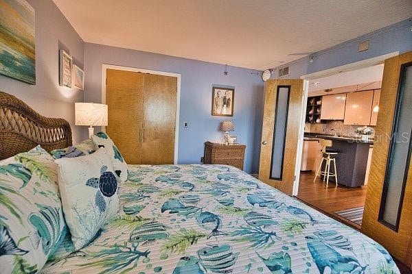 bedroom with hardwood / wood-style flooring and a closet