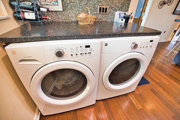 washroom featuring independent washer and dryer and hardwood / wood-style floors