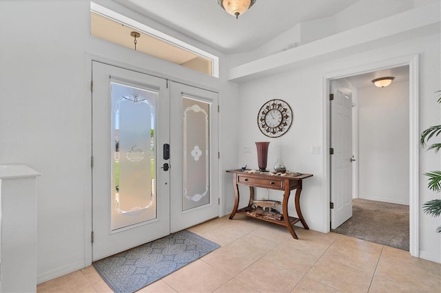 tiled entrance foyer with french doors and vaulted ceiling