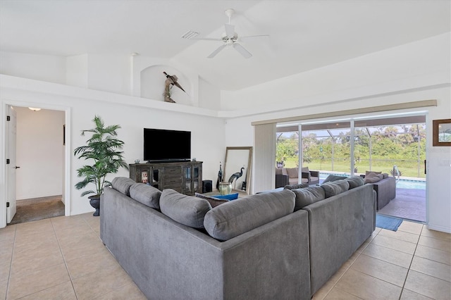 living room with ceiling fan, light tile patterned floors, and high vaulted ceiling