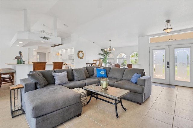 living room with ceiling fan, light tile patterned floors, and french doors