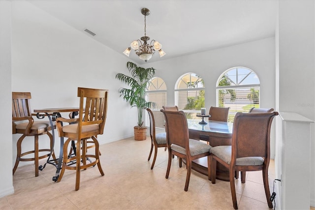 tiled dining room with an inviting chandelier