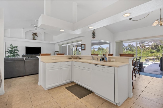 kitchen with white cabinetry, sink, high vaulted ceiling, light tile patterned flooring, and white dishwasher