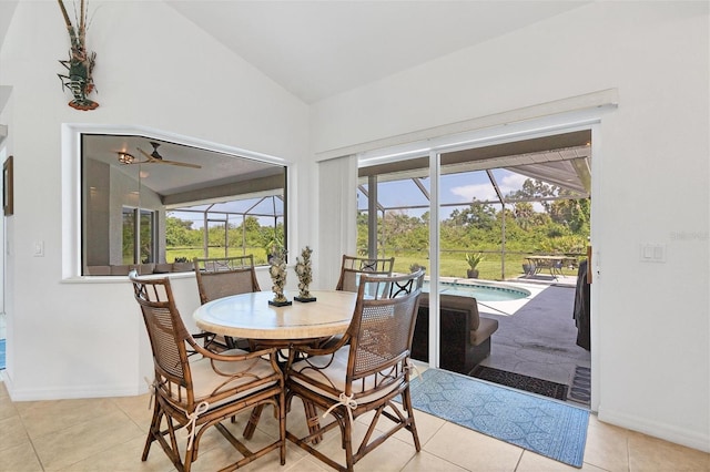 tiled dining room featuring ceiling fan and lofted ceiling