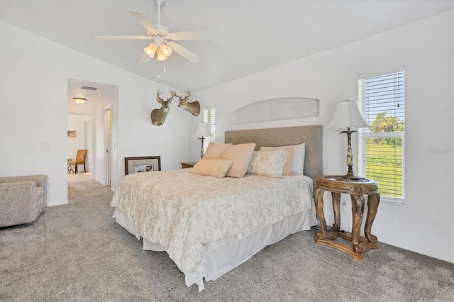 bedroom with ceiling fan, lofted ceiling, and carpet floors