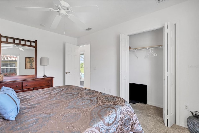 carpeted bedroom with ceiling fan and a closet