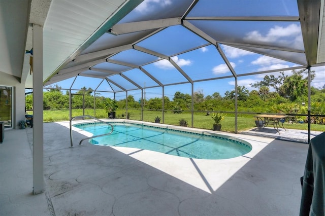 view of pool featuring a lanai, a patio area, and a lawn