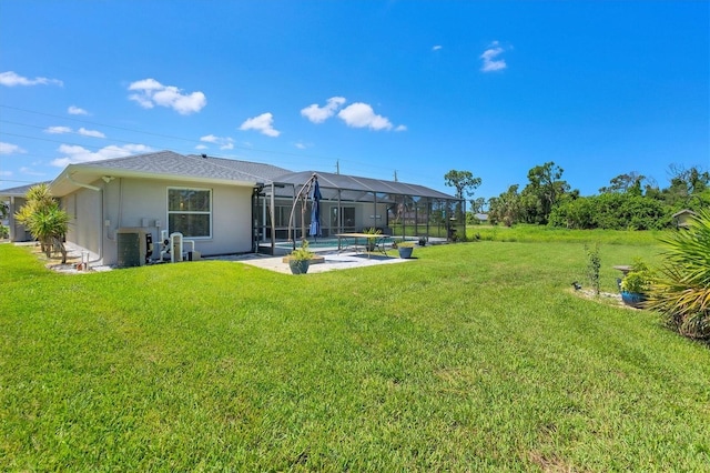 back of house with a lanai, central AC, a yard, and a patio