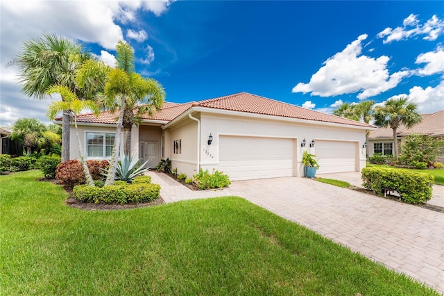 mediterranean / spanish house with a front yard and a garage