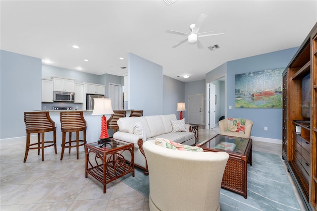 tiled living room featuring ceiling fan