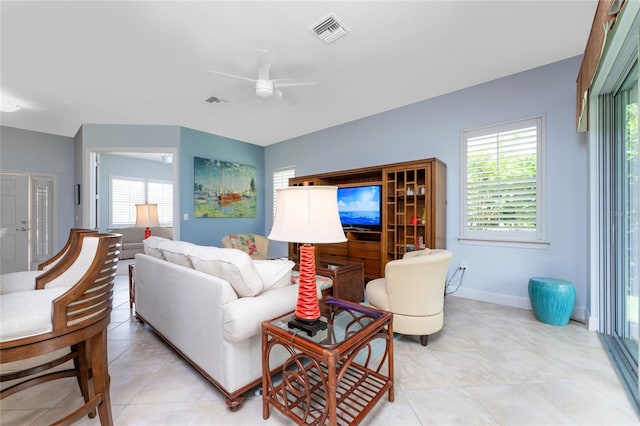 tiled living room with ceiling fan