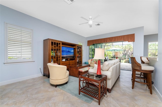 tiled living room with ceiling fan