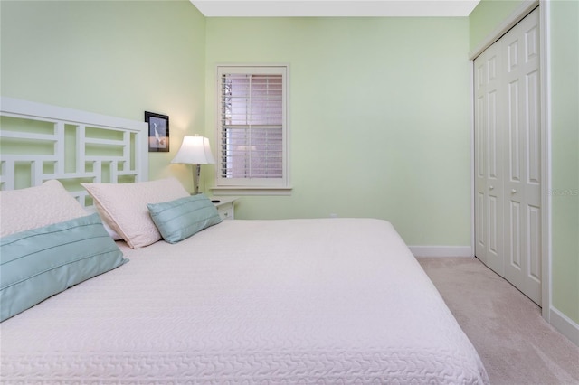 bedroom with light colored carpet and a closet