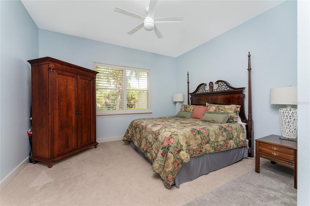 bedroom with ceiling fan and light carpet