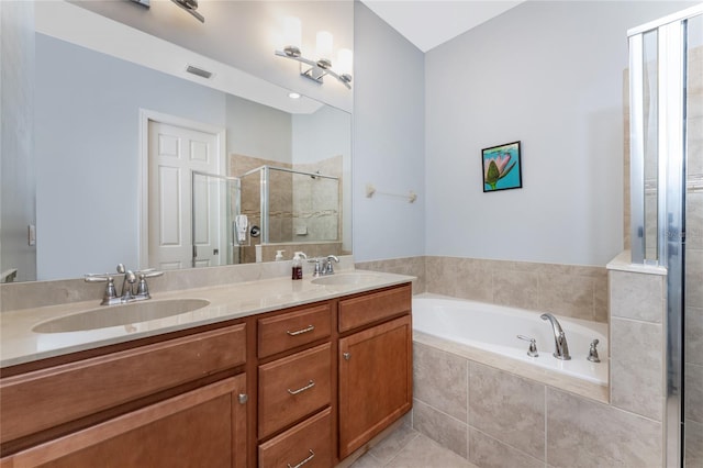 bathroom featuring tile patterned flooring, shower with separate bathtub, and vanity