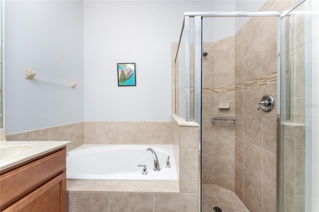 bathroom with vanity and separate shower and tub