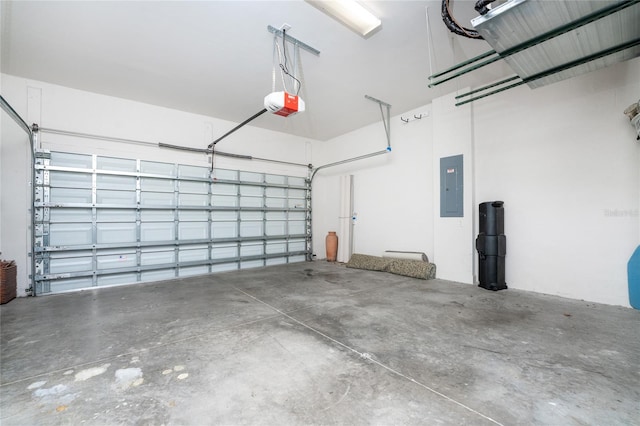 garage with a garage door opener and electric panel