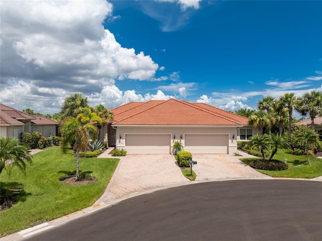 mediterranean / spanish-style house with a front lawn and a garage